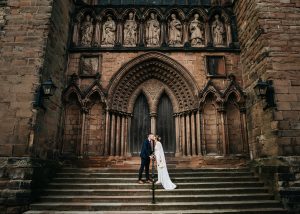 Portraits of the bride and groom outside lichfield cathedral on their wedding day